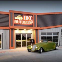 Exterior of OKC autobody with green car parked in front